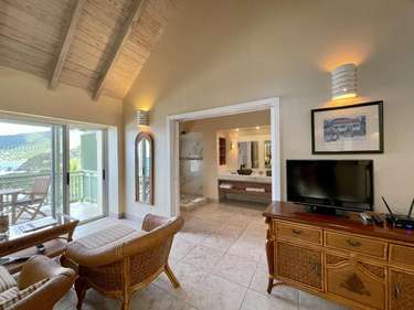 Sunlit living room with cozy seating and scenic views