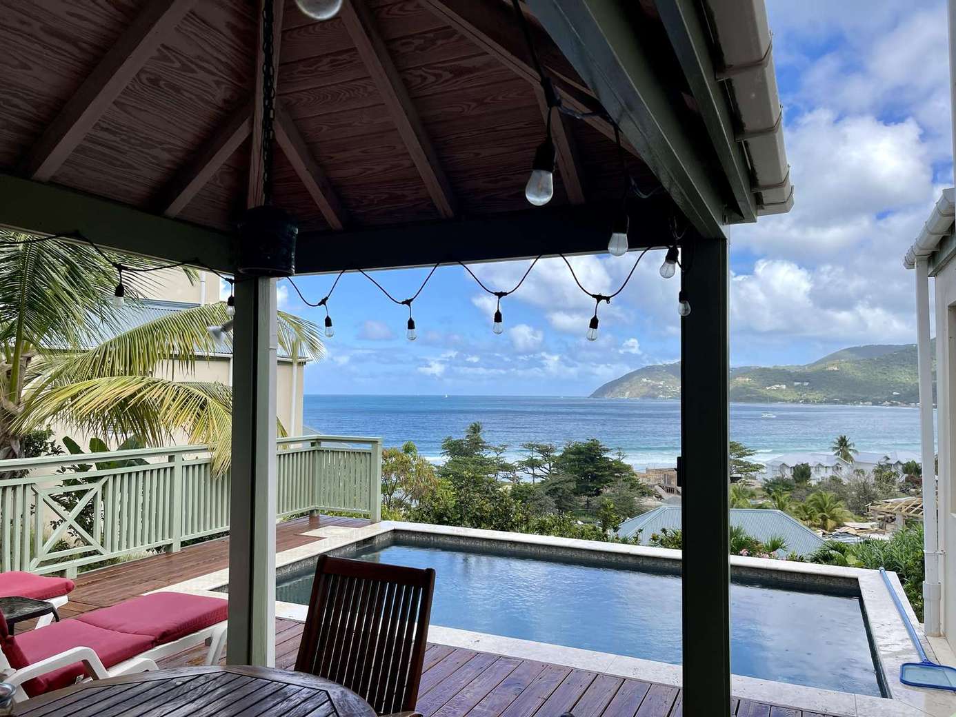 Ocean-view patio with pool and cozy lounge seating
