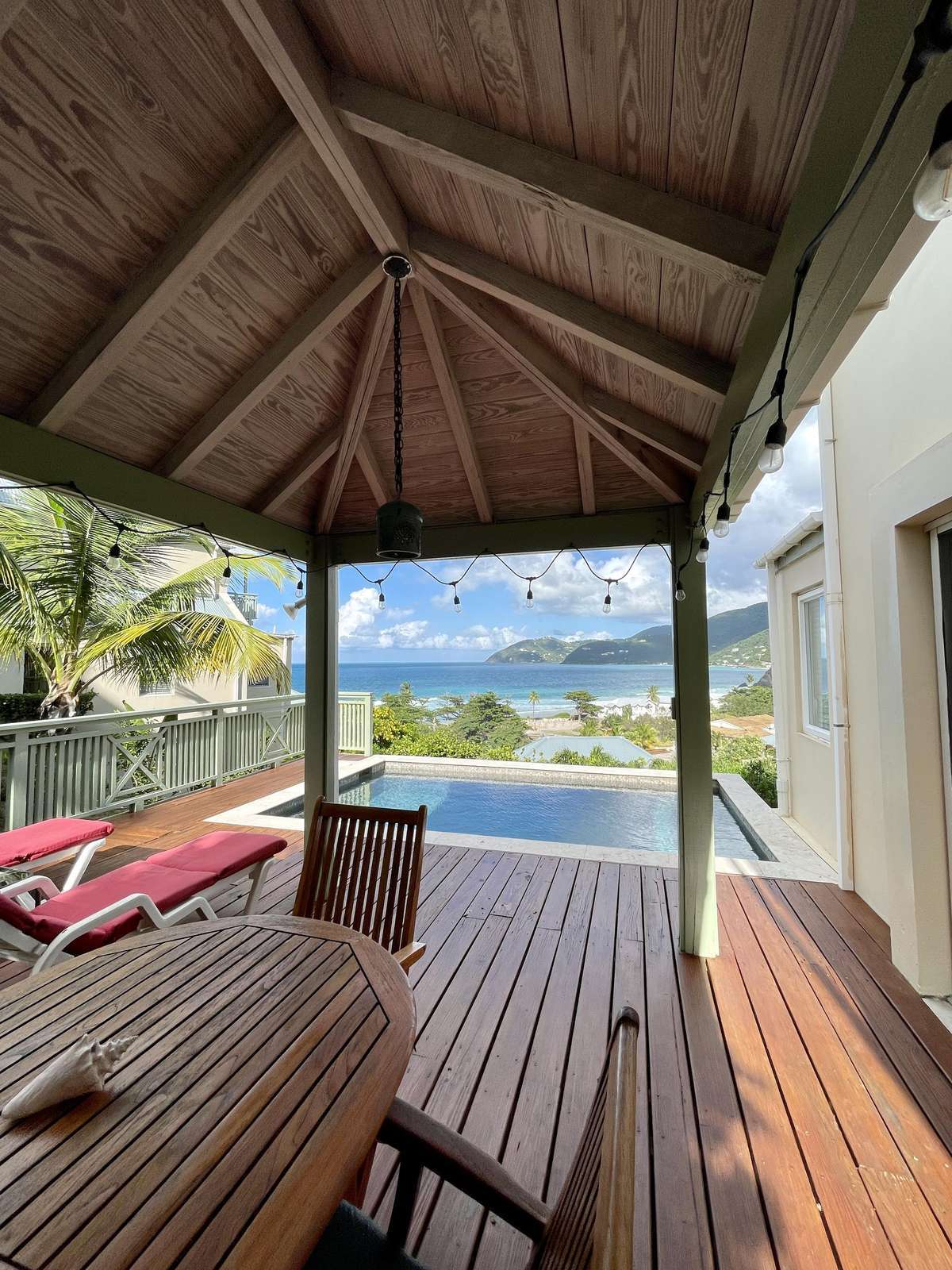 Covered patio with lake views and cozy seating area