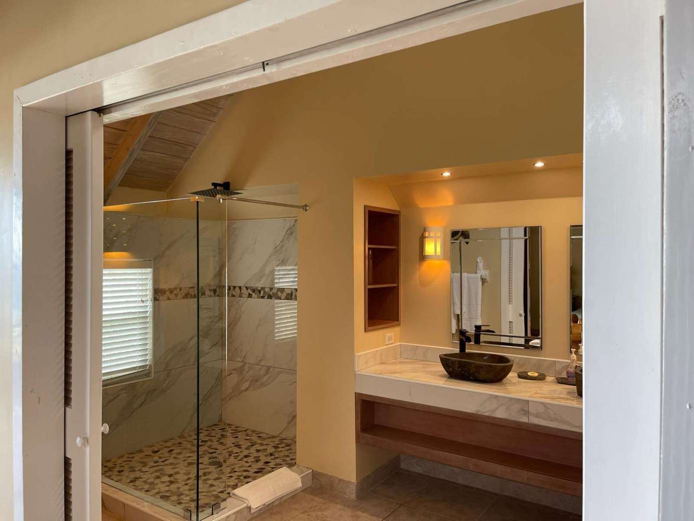 Spa-inspired bathroom with glass-enclosed rainfall shower