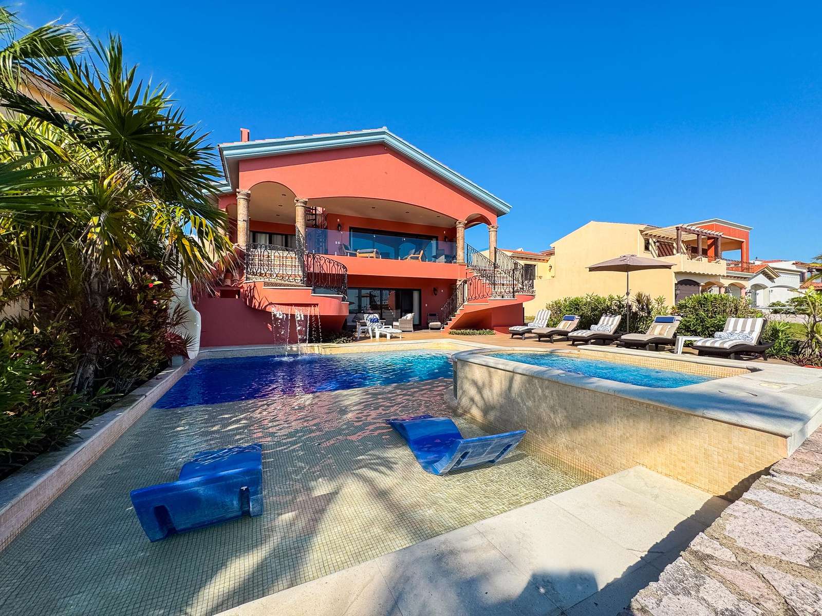 Sun-soaked poolside retreat with spacious outdoor lounge - property