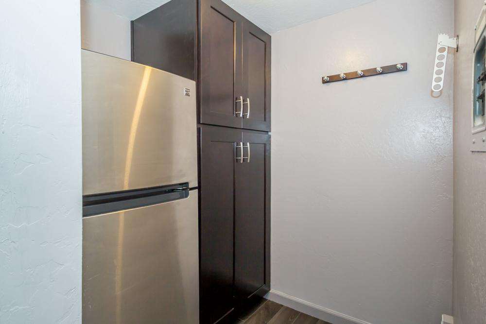 Walk-in closet has the refrigerator/freezer and cupboards for storage (behind kitchen)