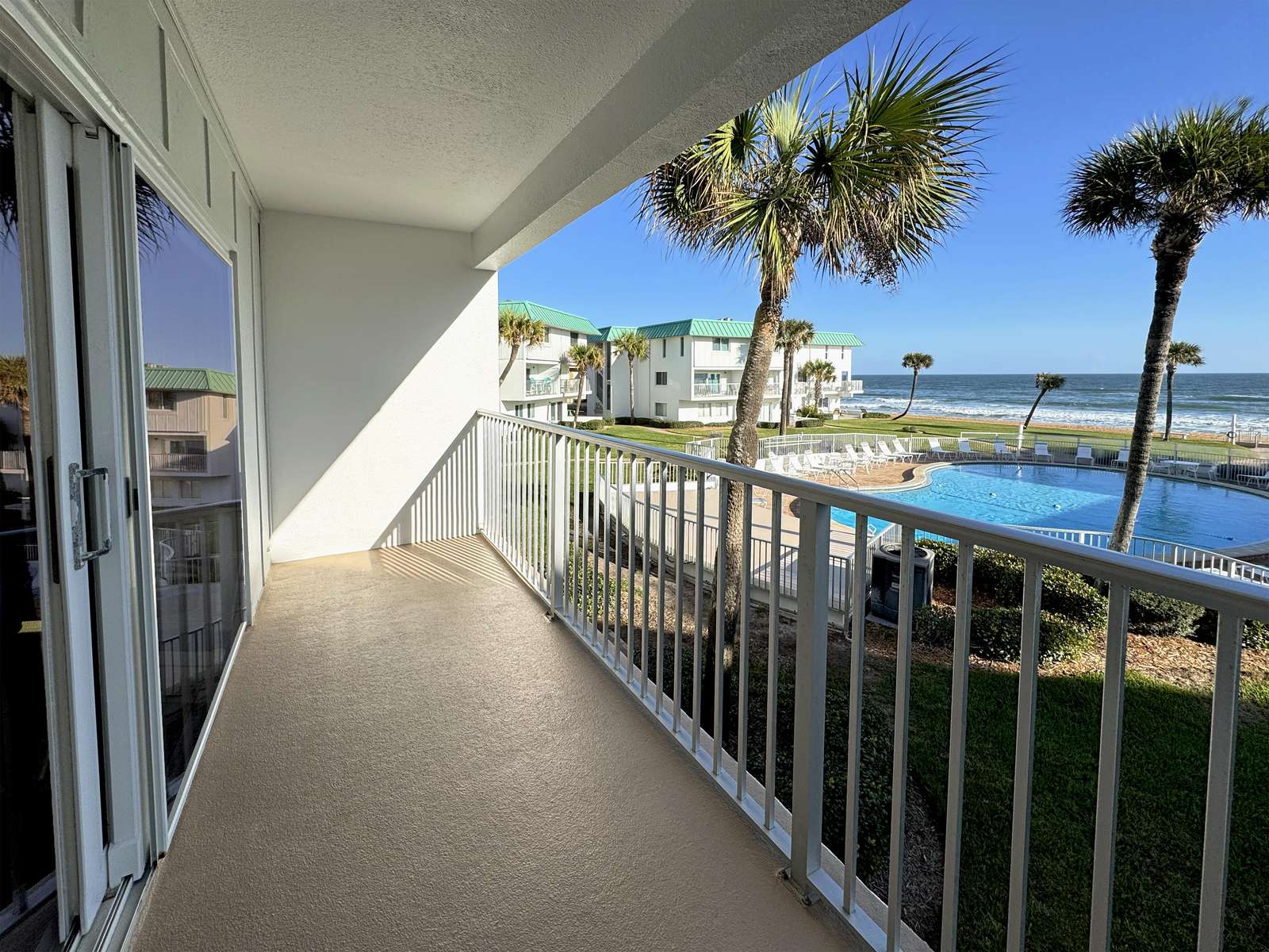 Spacious balcony with waterfront views and gentle sea breeze - property
