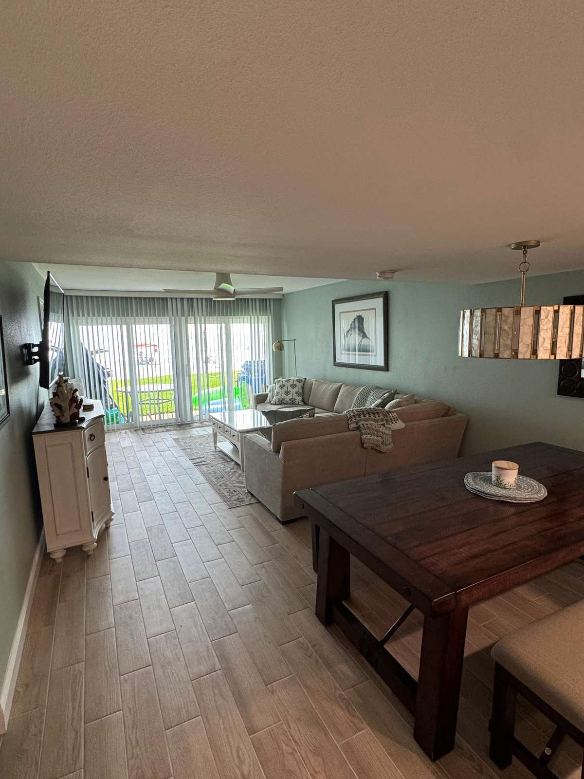 Spacious open living and dining area with garden views - property