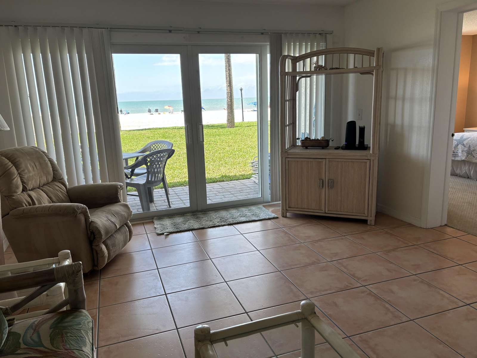 Cozy living room with ocean views and patio access - property