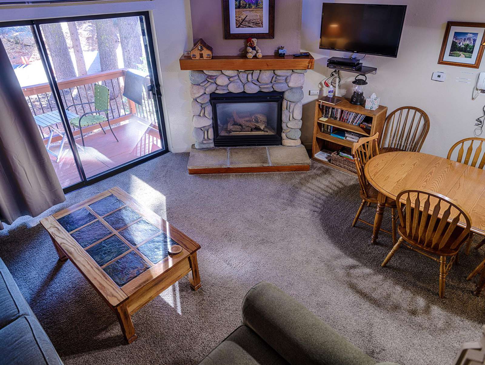 View of the living area with fireplace and balcony.