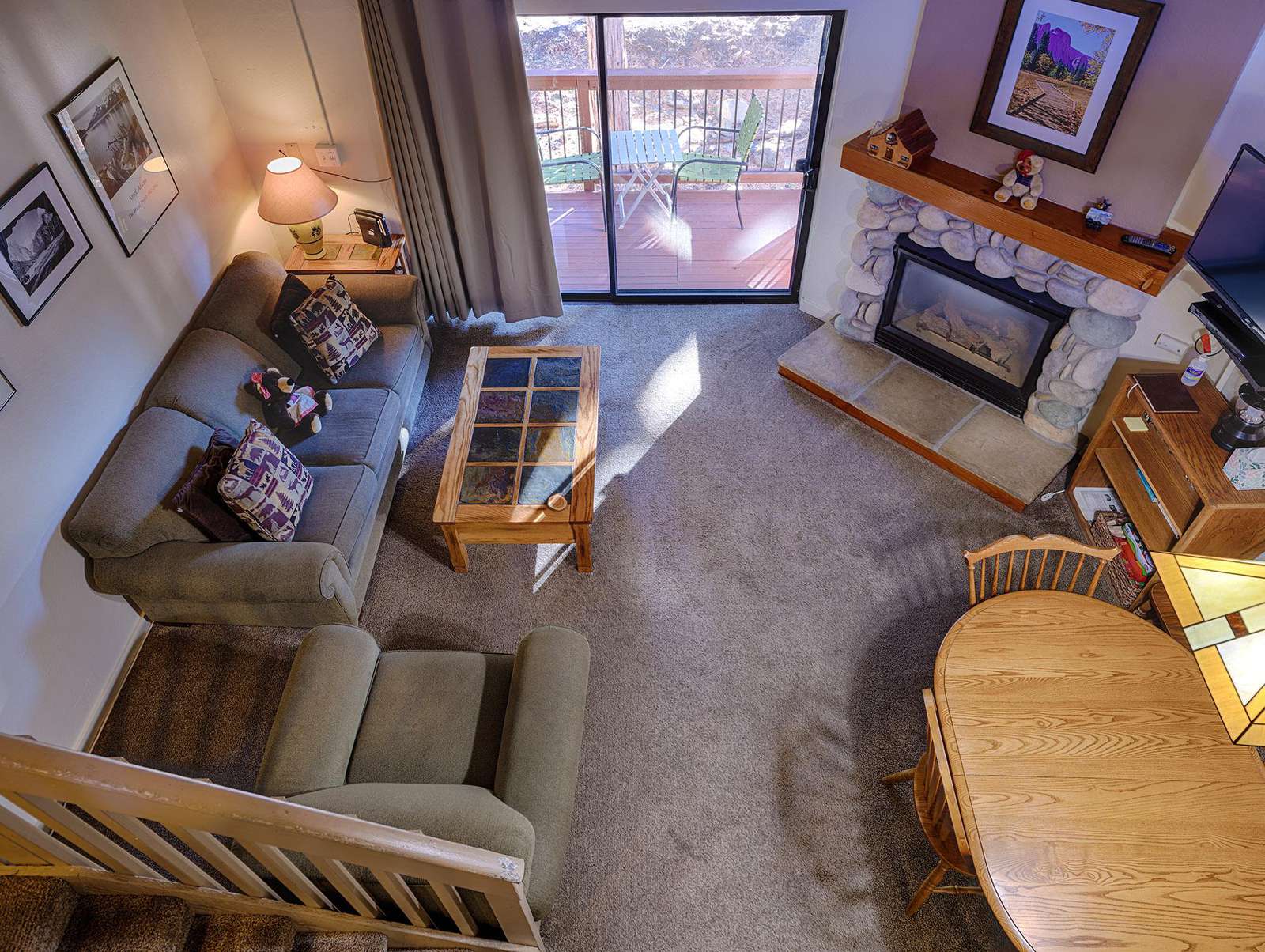 View of your living area with pullout queen sofa sleeper, dining area, fireplace and deck.