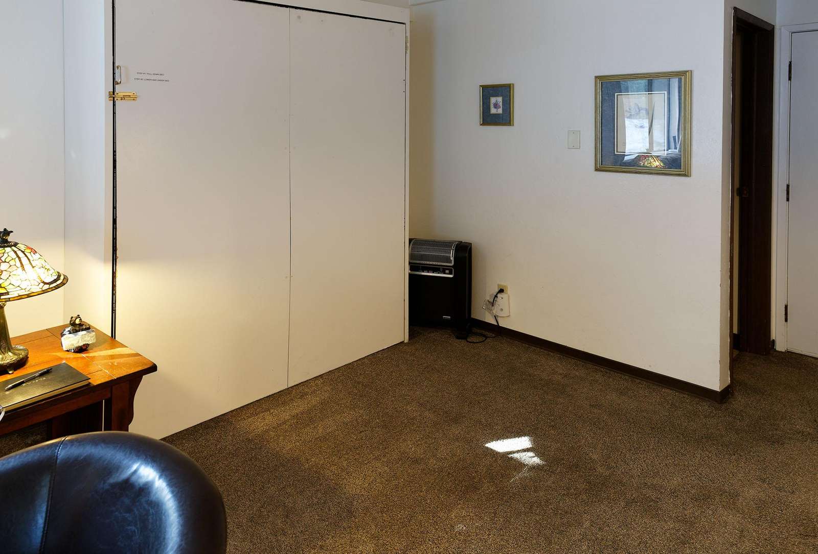 Murphy bed offers extra space when folded up into the wall.