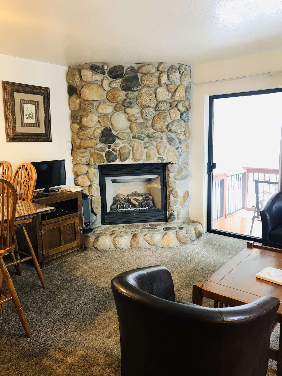 Dining area, gas fireplace and satellite TV.