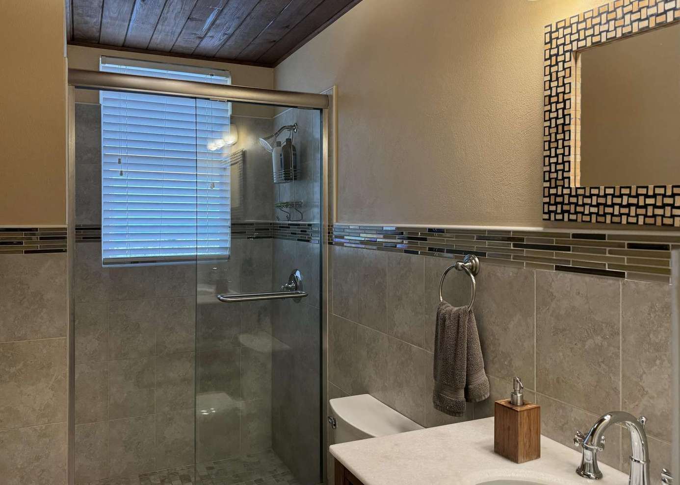 Modern bathroom with glass shower and elegant tile accents