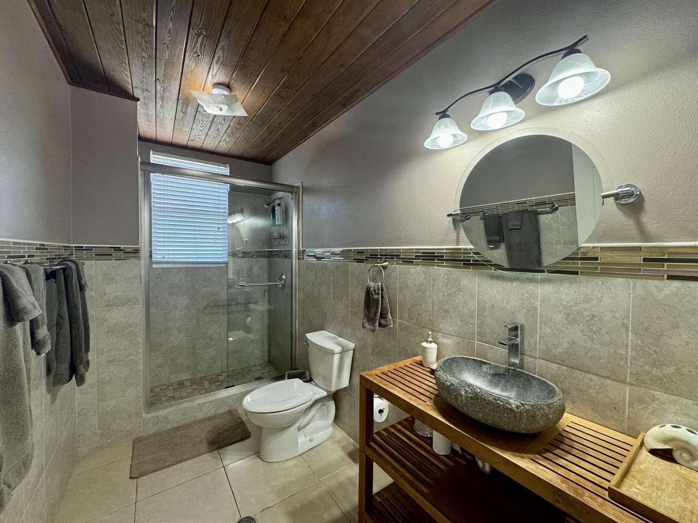 Cozy bathroom retreat with rustic wood and stone accents