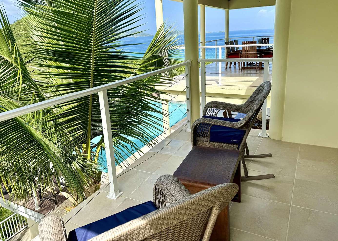 Relax on the sunny balcony with ocean views and cozy seating