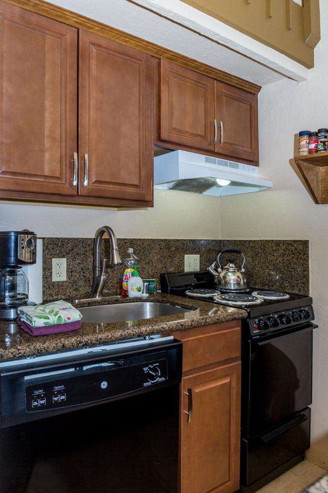 Kitchen is complete with stove-top oven, dishwasher, microwave, coffee maker, toaster and blender.