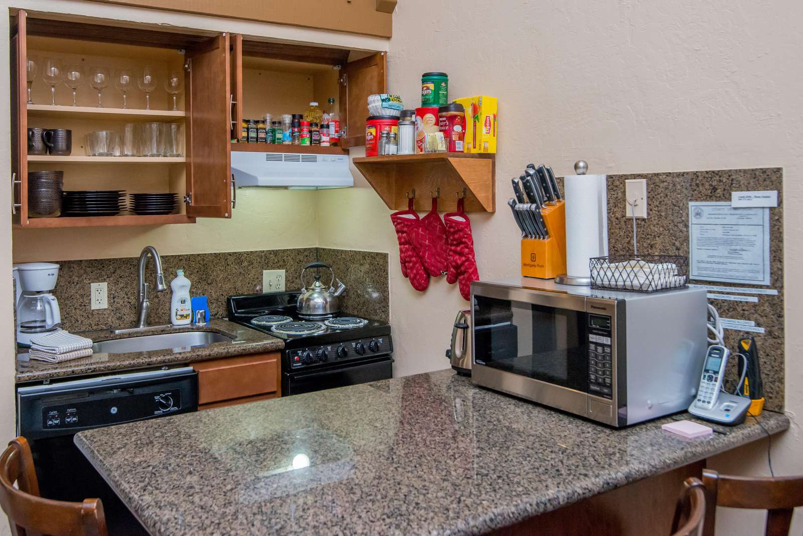 Cupboards are stocked with dishes and glasses. Spices, coffees, cooking oil, utensils and plenty of other kitchen amenities provided for your comfort.