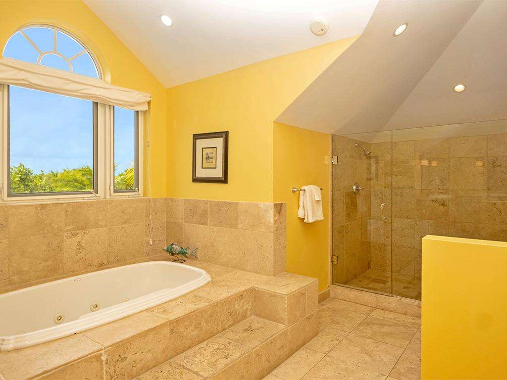 Sunlit bathroom with spacious tub and walk-in shower