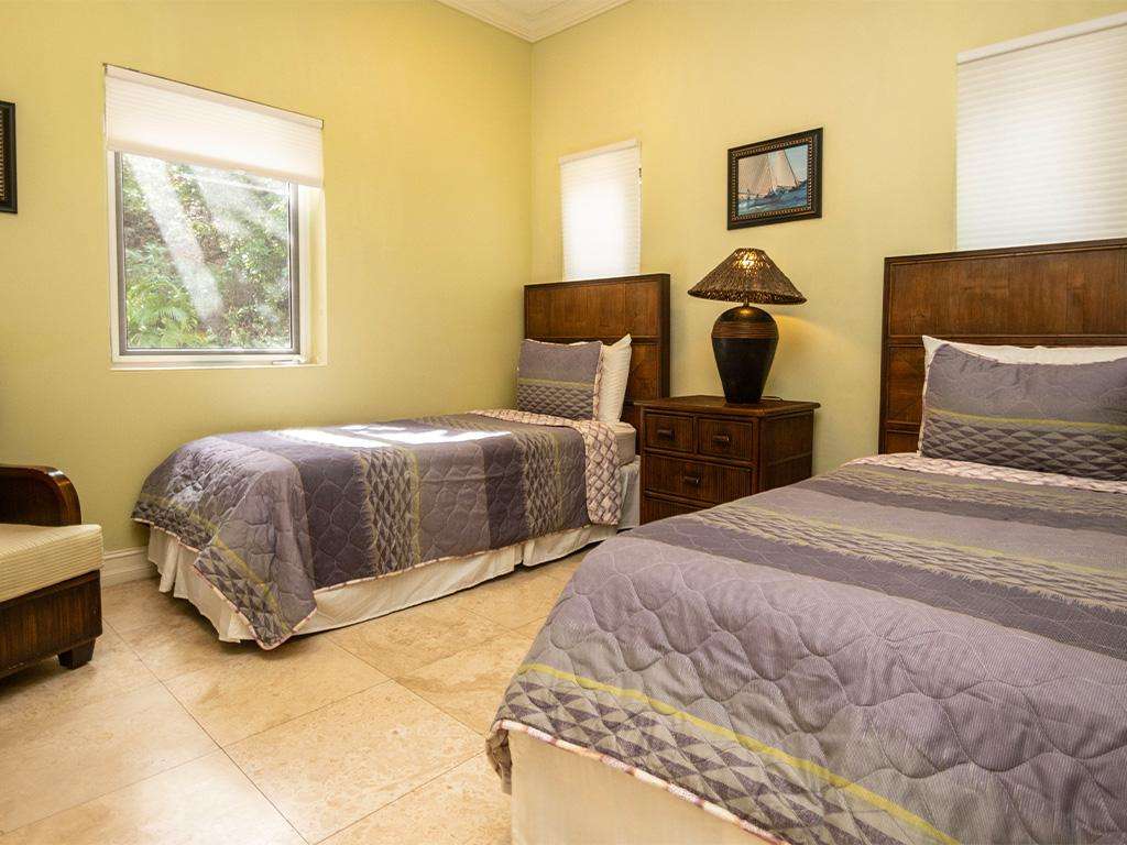 Cozy twin bedroom with warm lighting and garden views