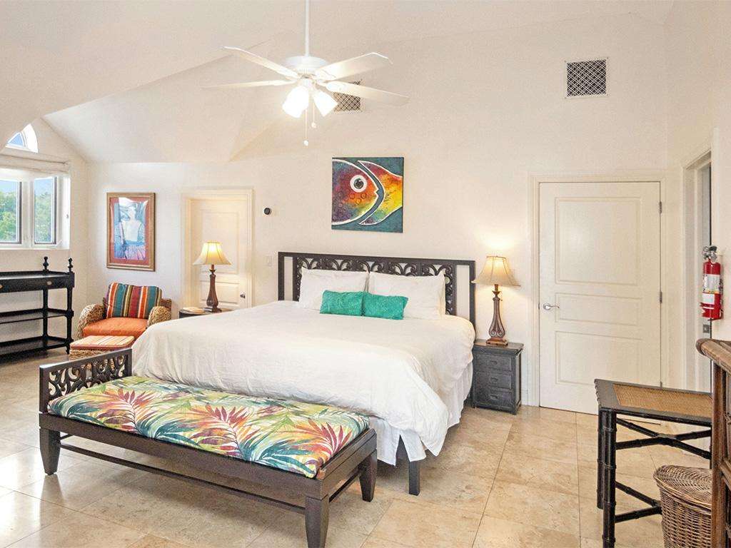 Spacious bedroom with vibrant bench and cozy ambiance