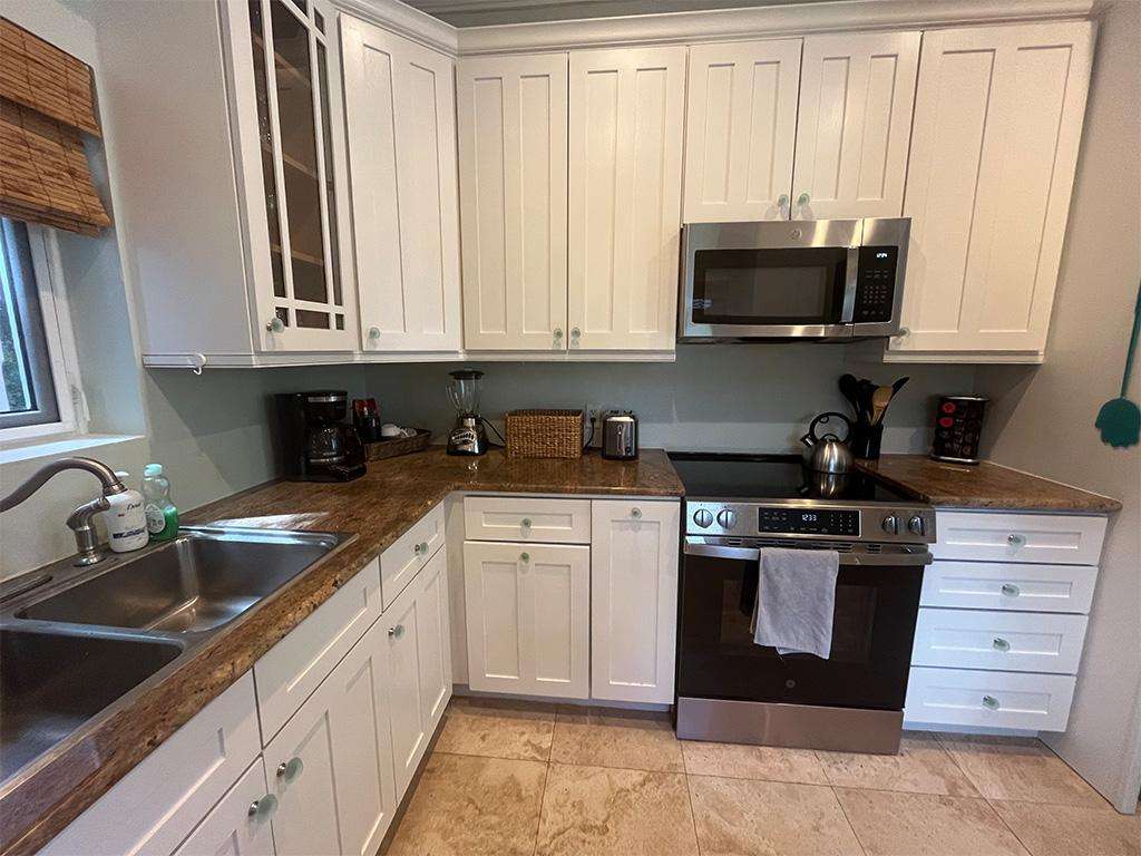 Bright, fully equipped kitchen with modern appliances and ample counter space