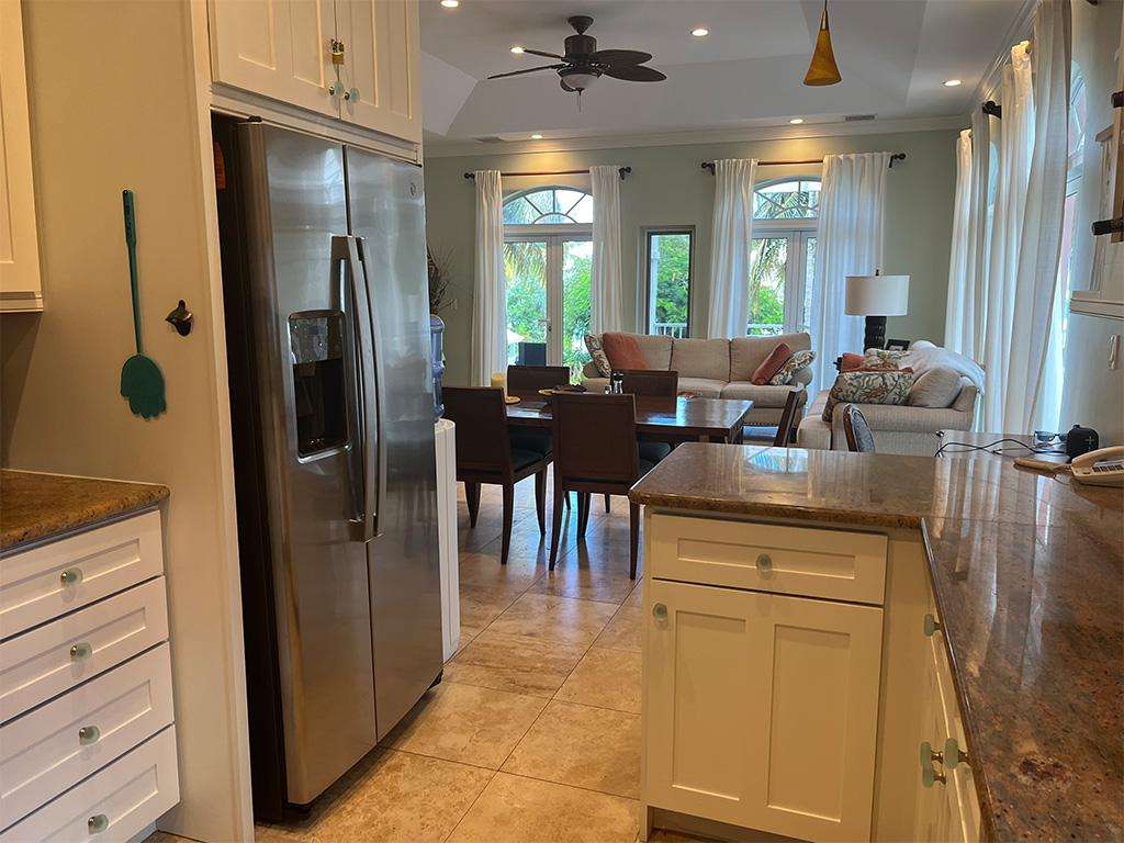 Bright, open kitchen flowing into cozy living and dining area
