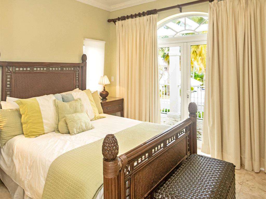 Cozy bedroom retreat with garden-view French doors