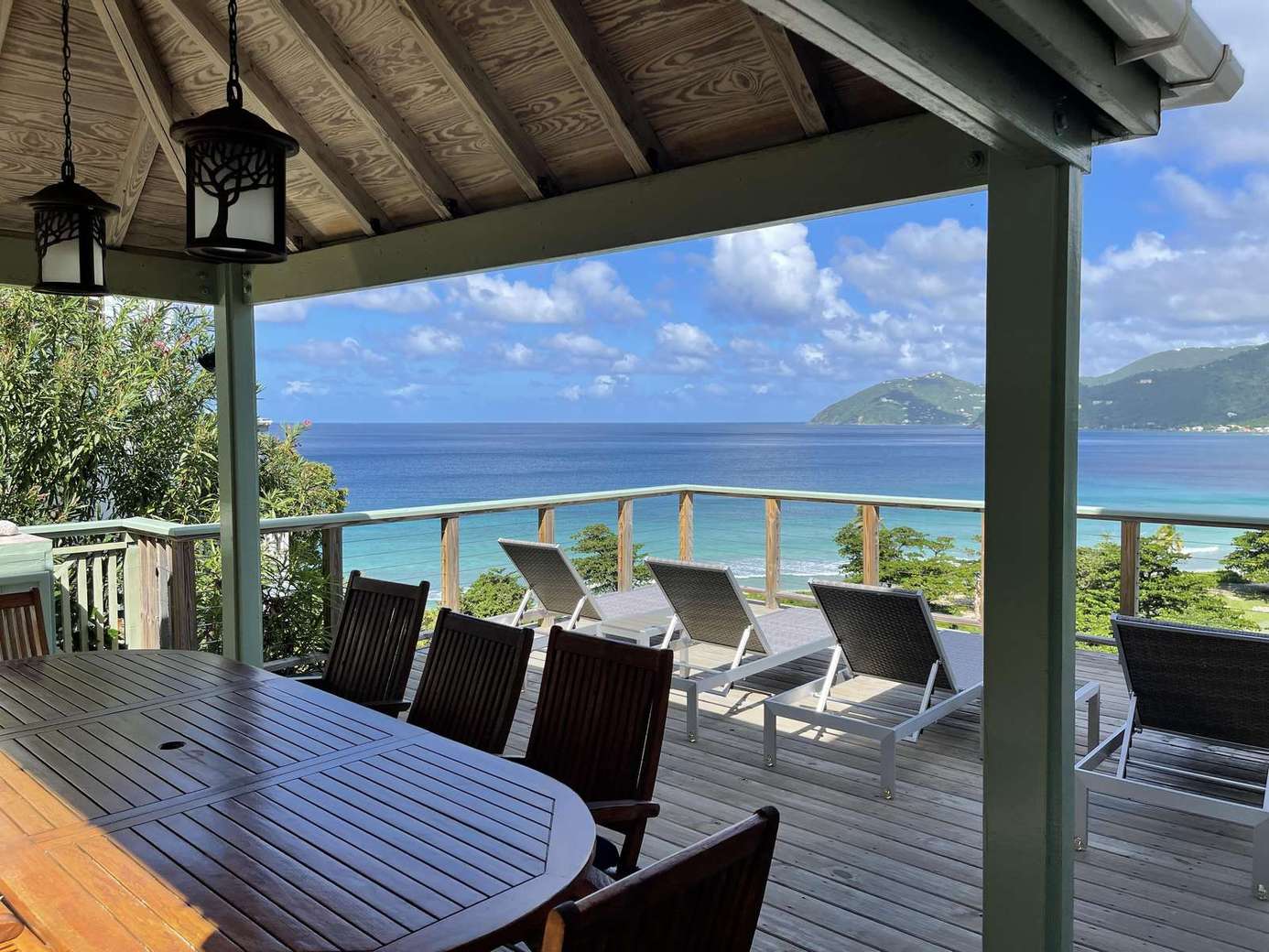 Spacious oceanfront deck with dining and lounge seating
