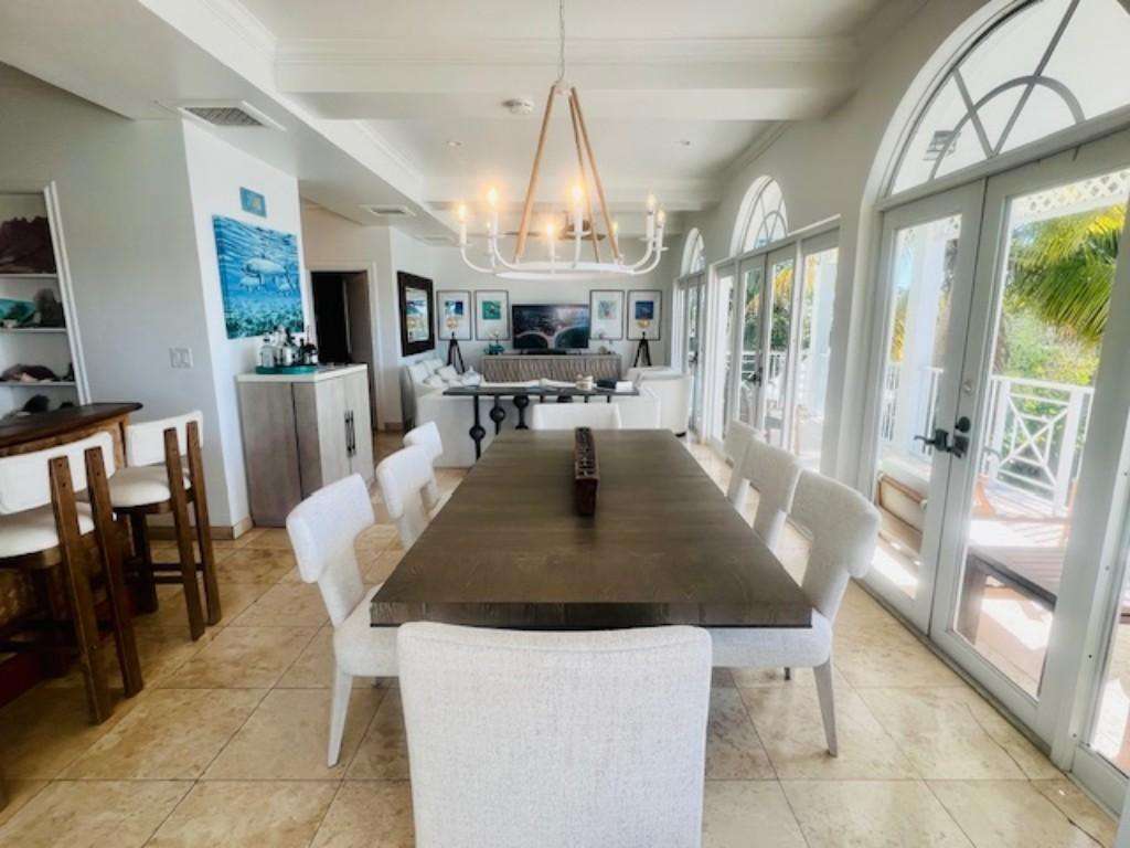 Sunlit dining area with elegant chandelier and garden views