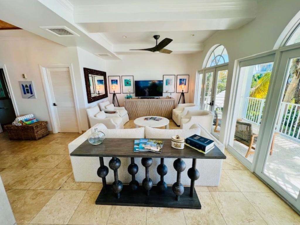 Sunlit living room with cozy seating and garden views