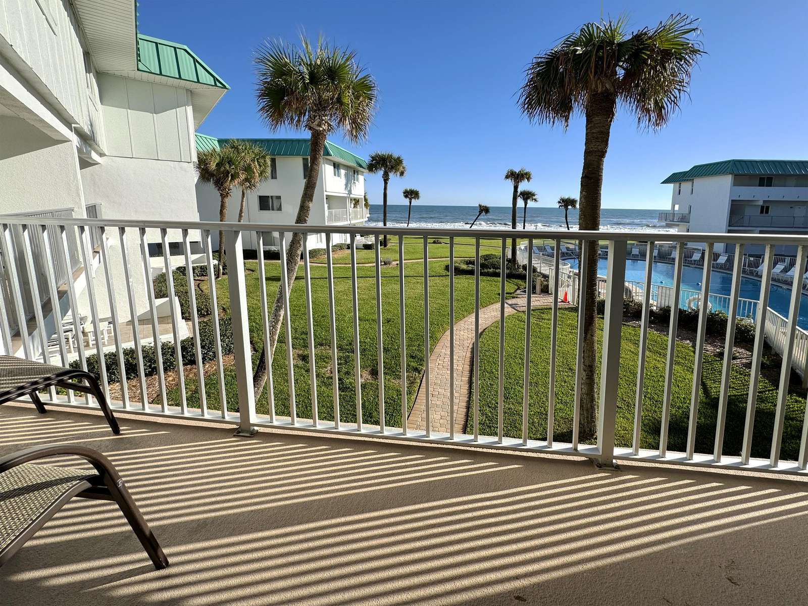 Sunny balcony with waterfront views and gentle sea breeze - property