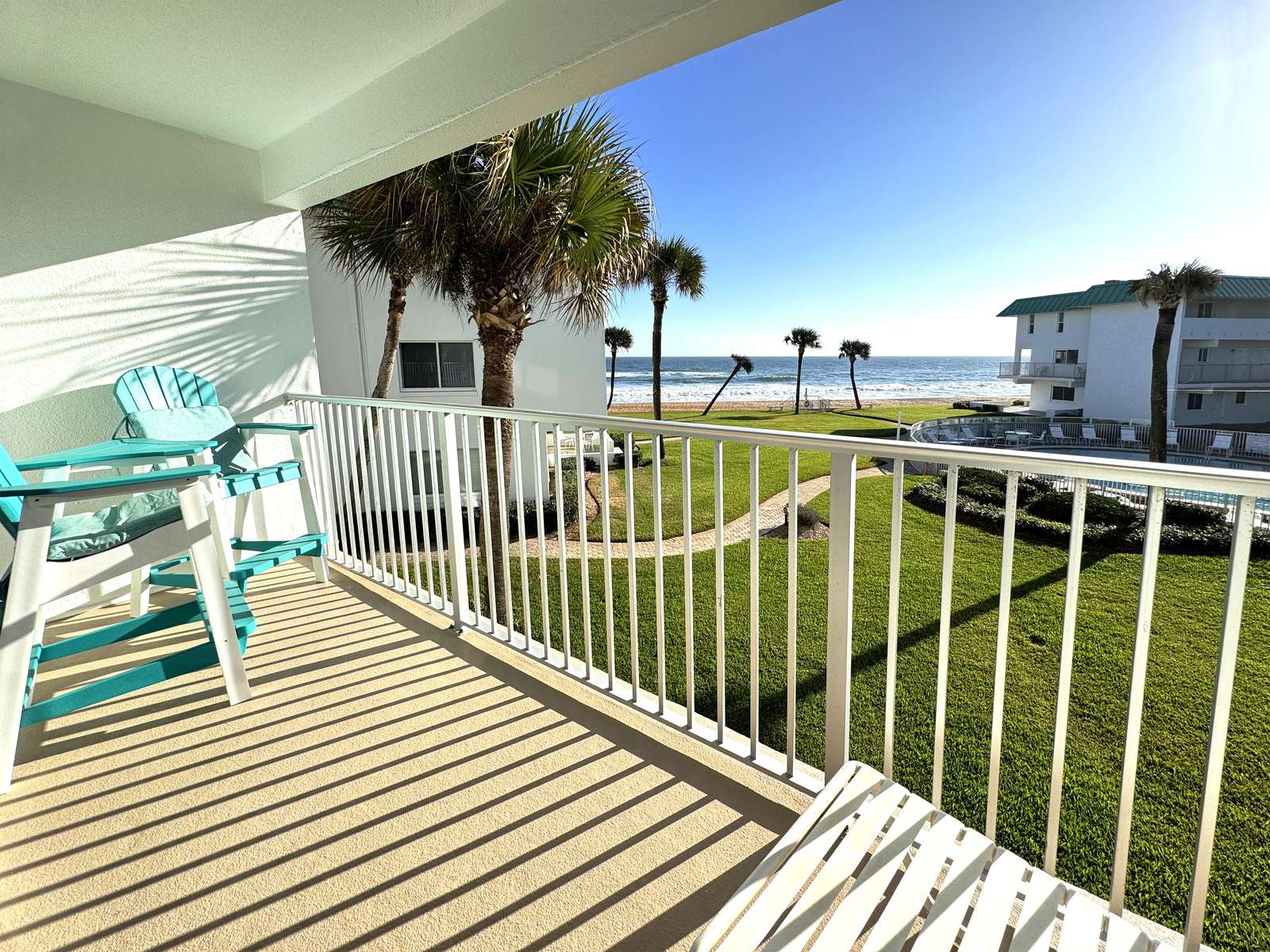 Sunlit balcony with ocean views and coastal breeze - property