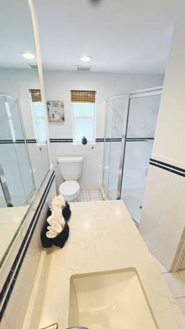 Bright, modern bathroom with sleek glass shower and ample counter space