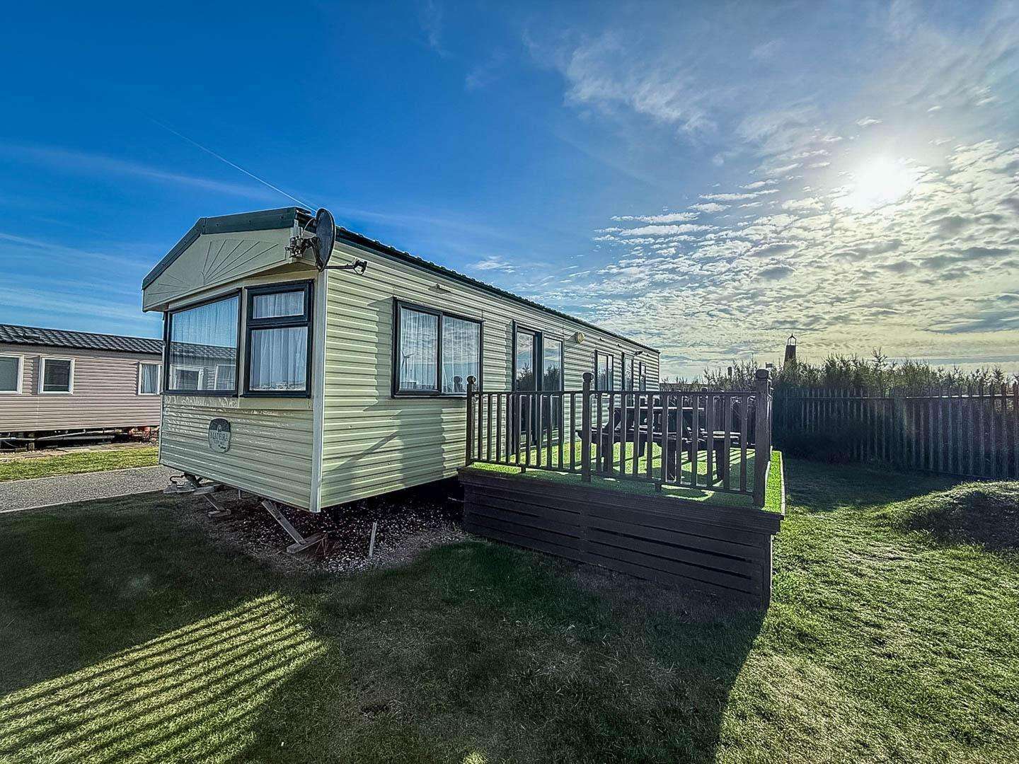 Elevate your holiday experience by choosing this 6 berth dog-friendly caravan with decking, creating your own private outdoor sanctuary. The decking area extends your living space, perfect for enjoying a morning coffee or letting your dog play safely. - property