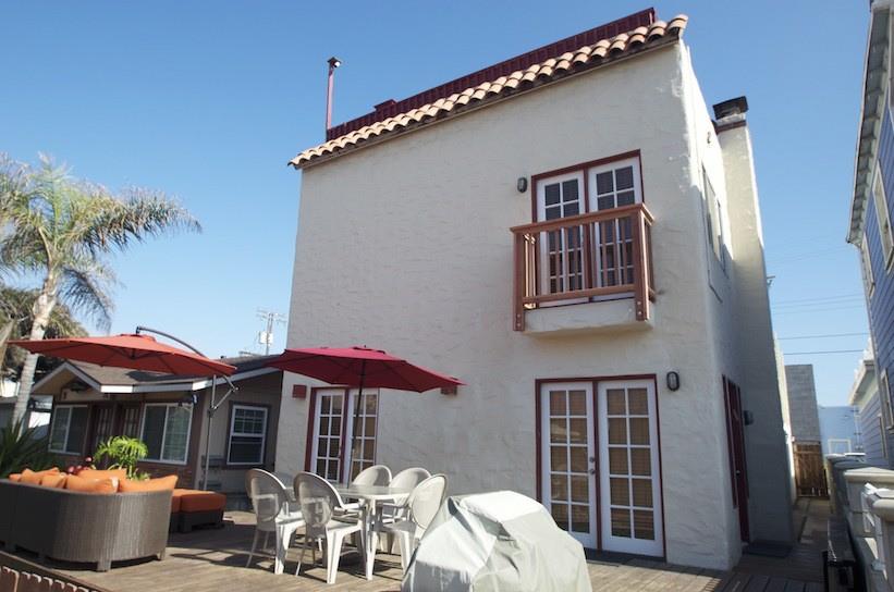 Front of House with Barbecue, Table and Chairs and Patio Furniture