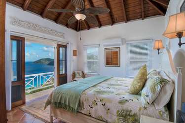 Serene bedroom with ocean views and tropical breeze