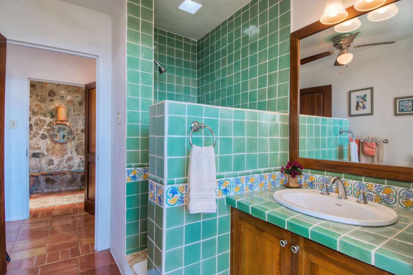 Charming bathroom with vibrant green tile and mexican accents