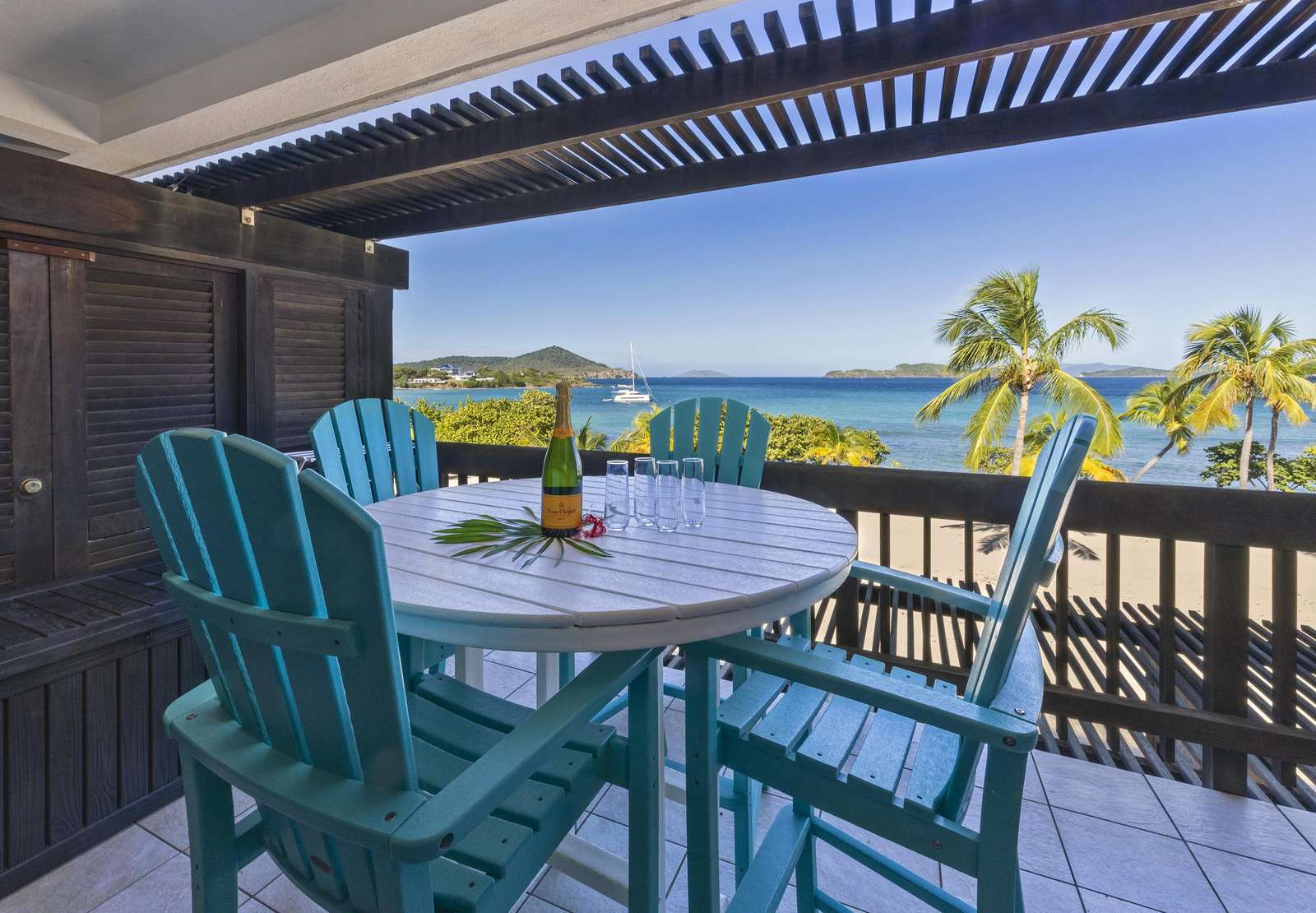 Sunlit patio with panoramic ocean and mountain views - property