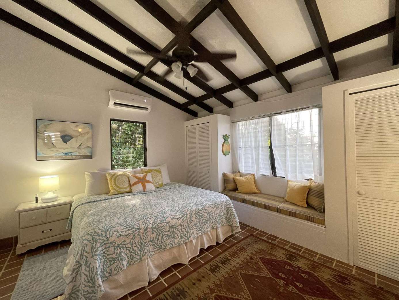 Cozy bedroom retreat with vaulted beams and window seat