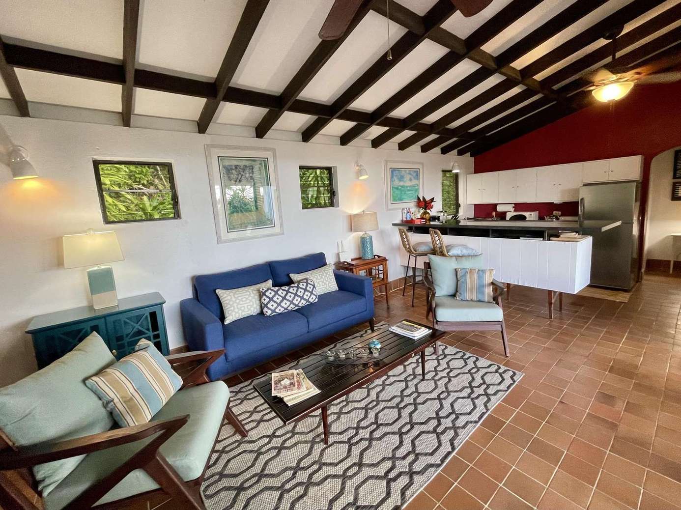 Cozy living room with vaulted beams and open kitchen flow