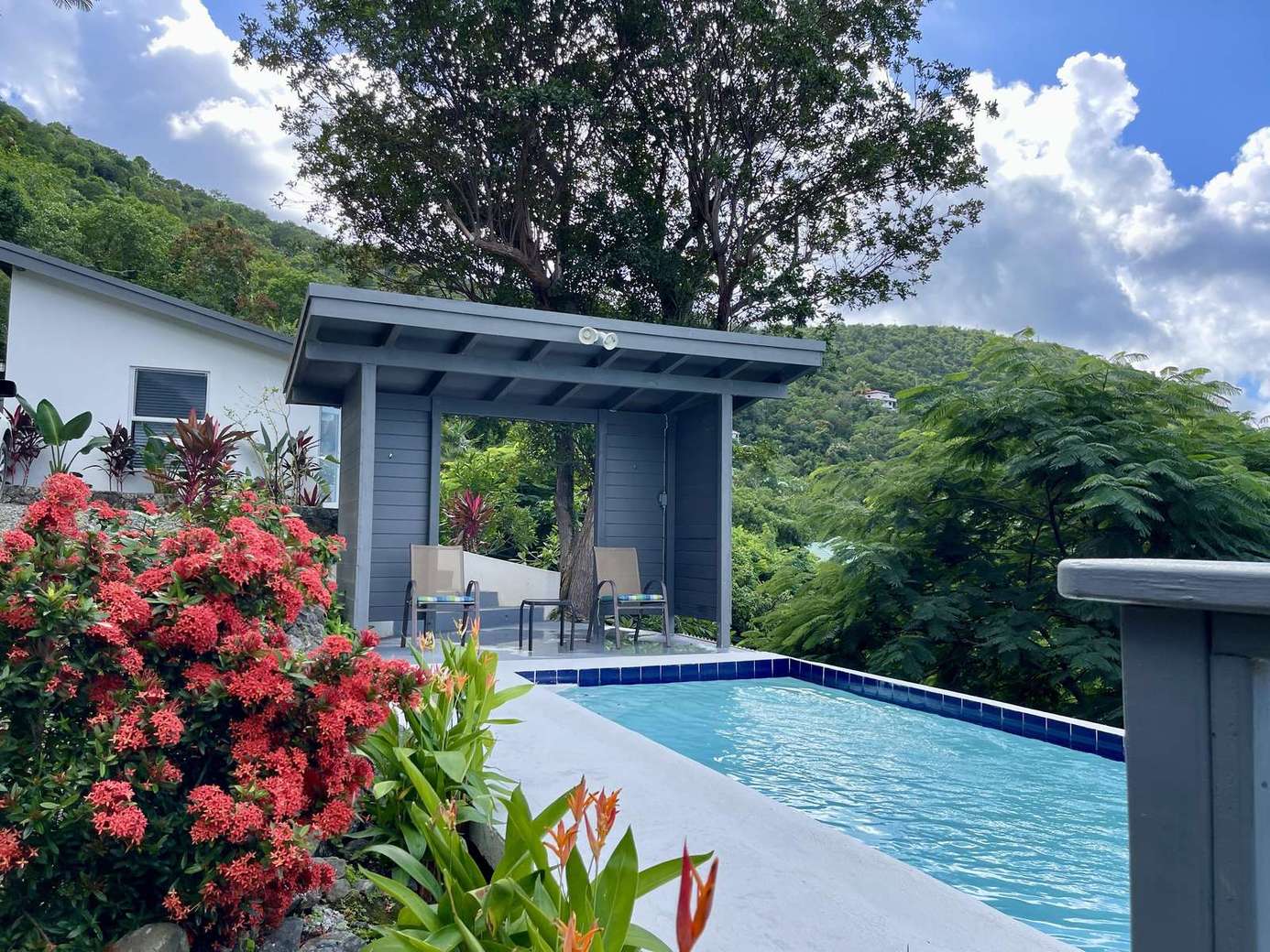 Secluded poolside retreat surrounded by lush greenery