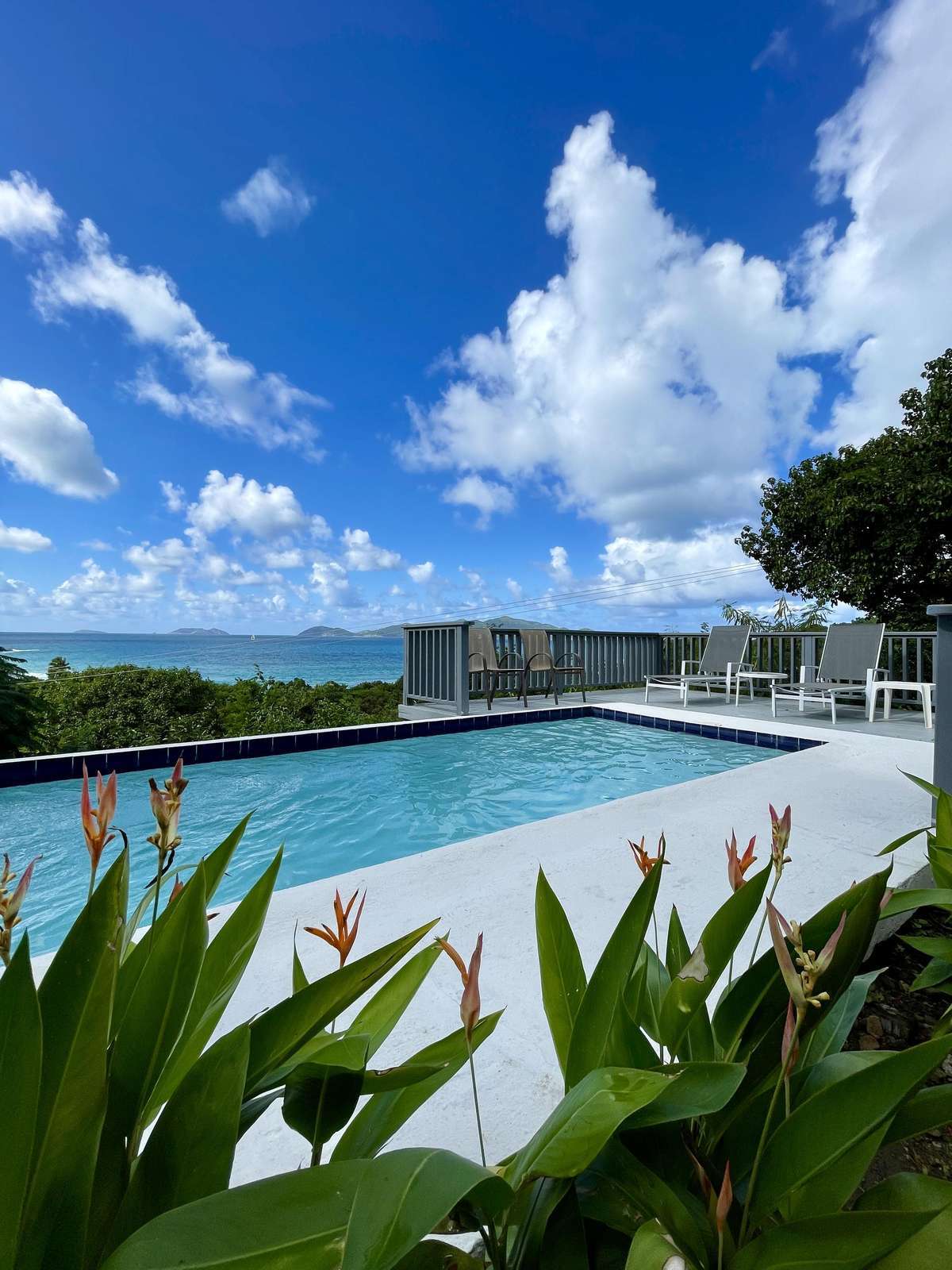 Sunlit poolside retreat with stunning sky views