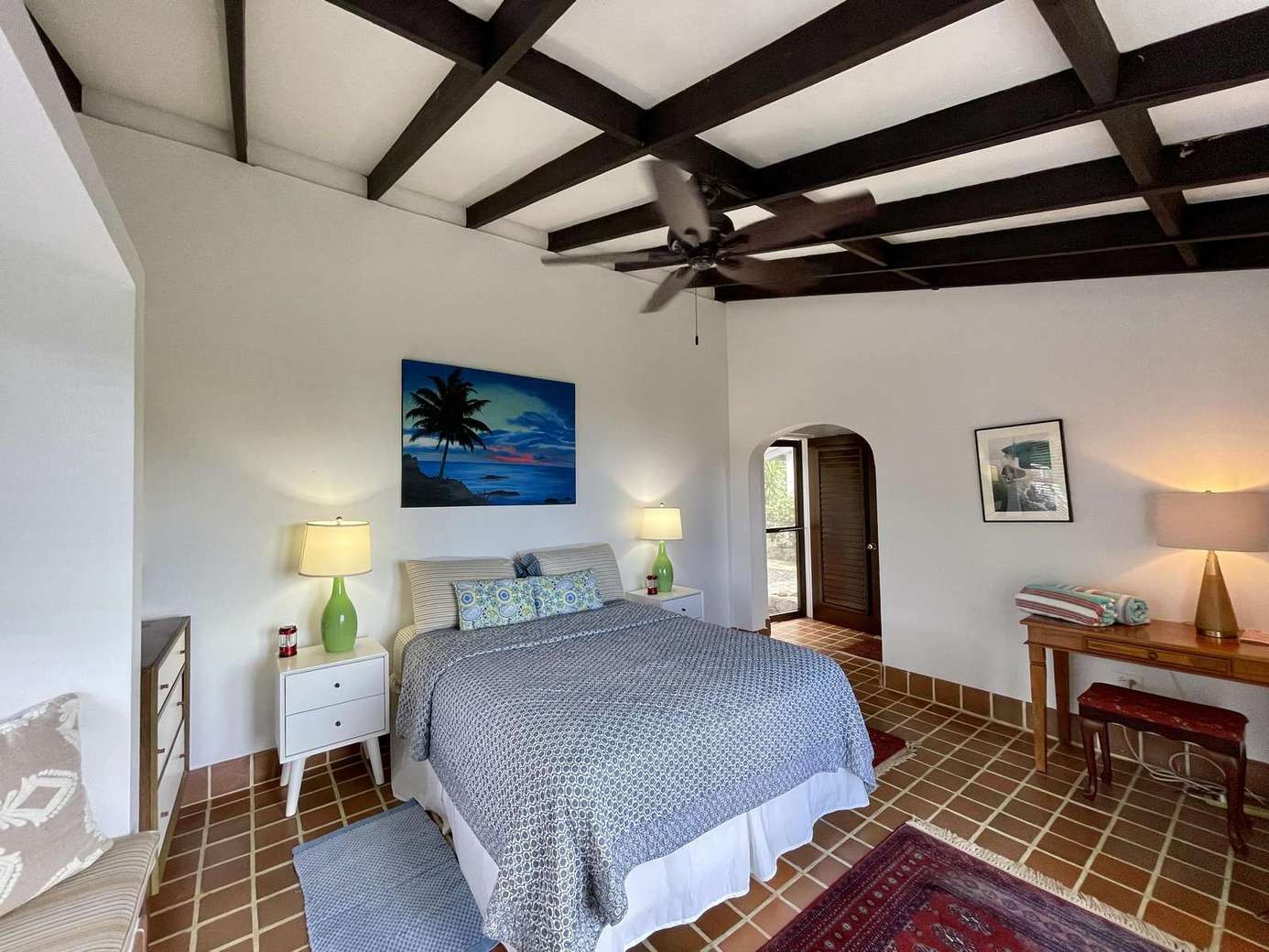 Cozy bedroom with vaulted ceilings and warm lighting