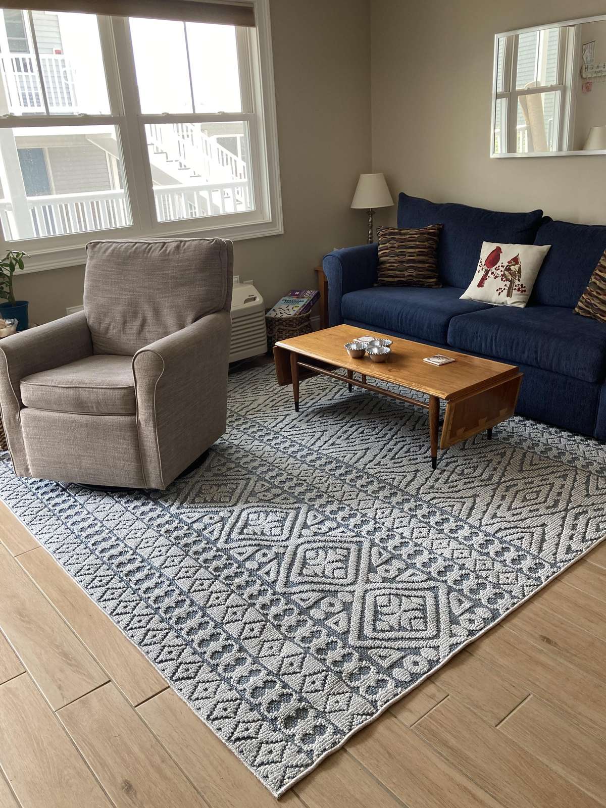 Cozy living room with plush seating and natural light - property