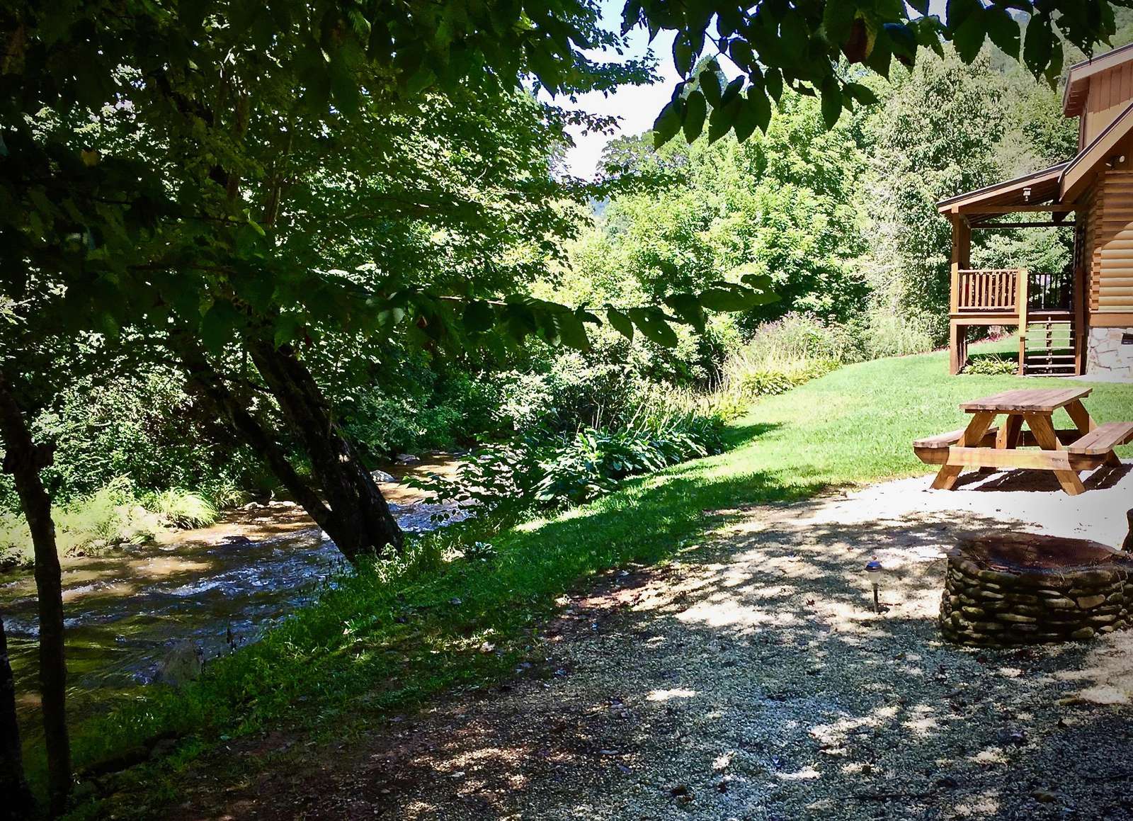 Covered Porch, Fire Pit, and the Hot Tub, are all Perfectly placed along the Creek!