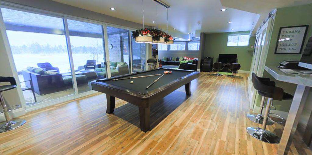 Lower floor entertainment area with bar and walkout