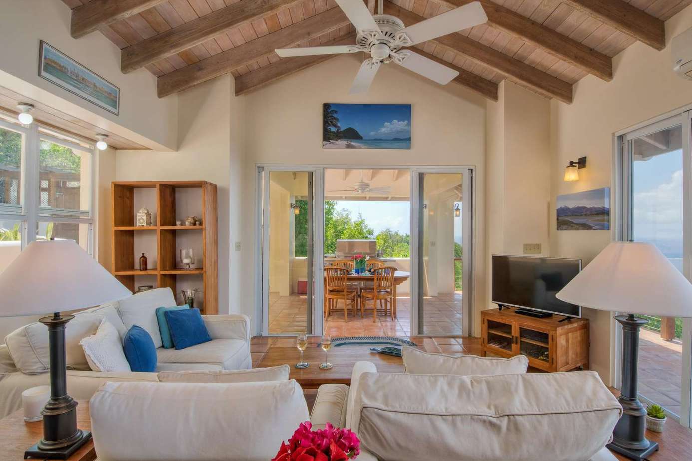 Sunlit living room with vaulted ceilings and garden views