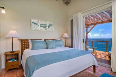 Serene bedroom with ocean views and private balcony retreat