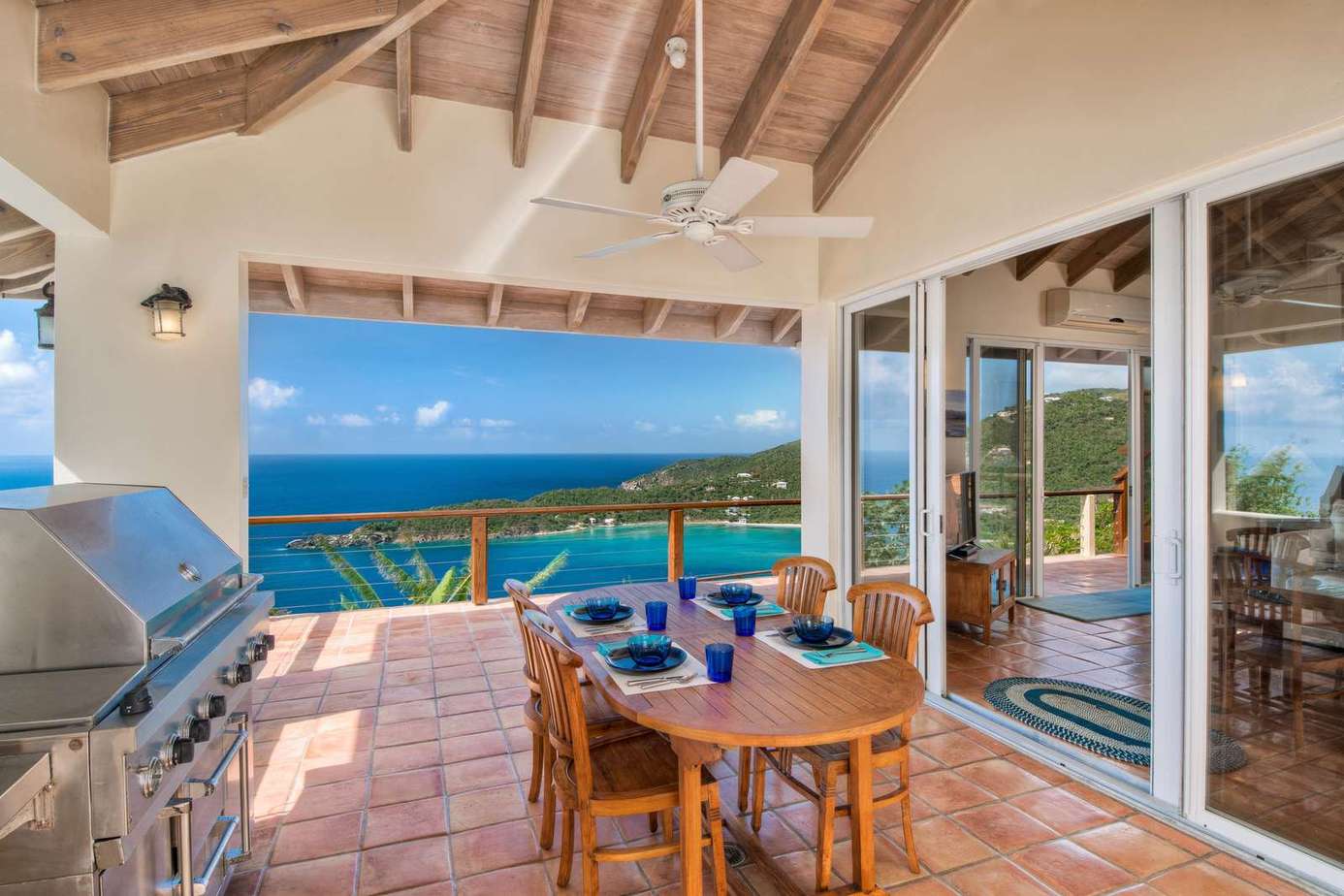 Ocean-view patio with dining and built-in grill for gatherings