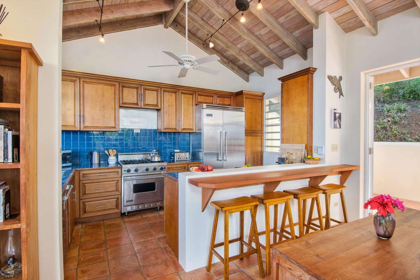 Spacious kitchen with vaulted ceilings and vibrant backsplash