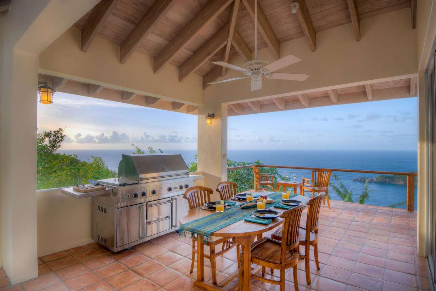 Spacious outdoor dining with panoramic ocean views and breeze