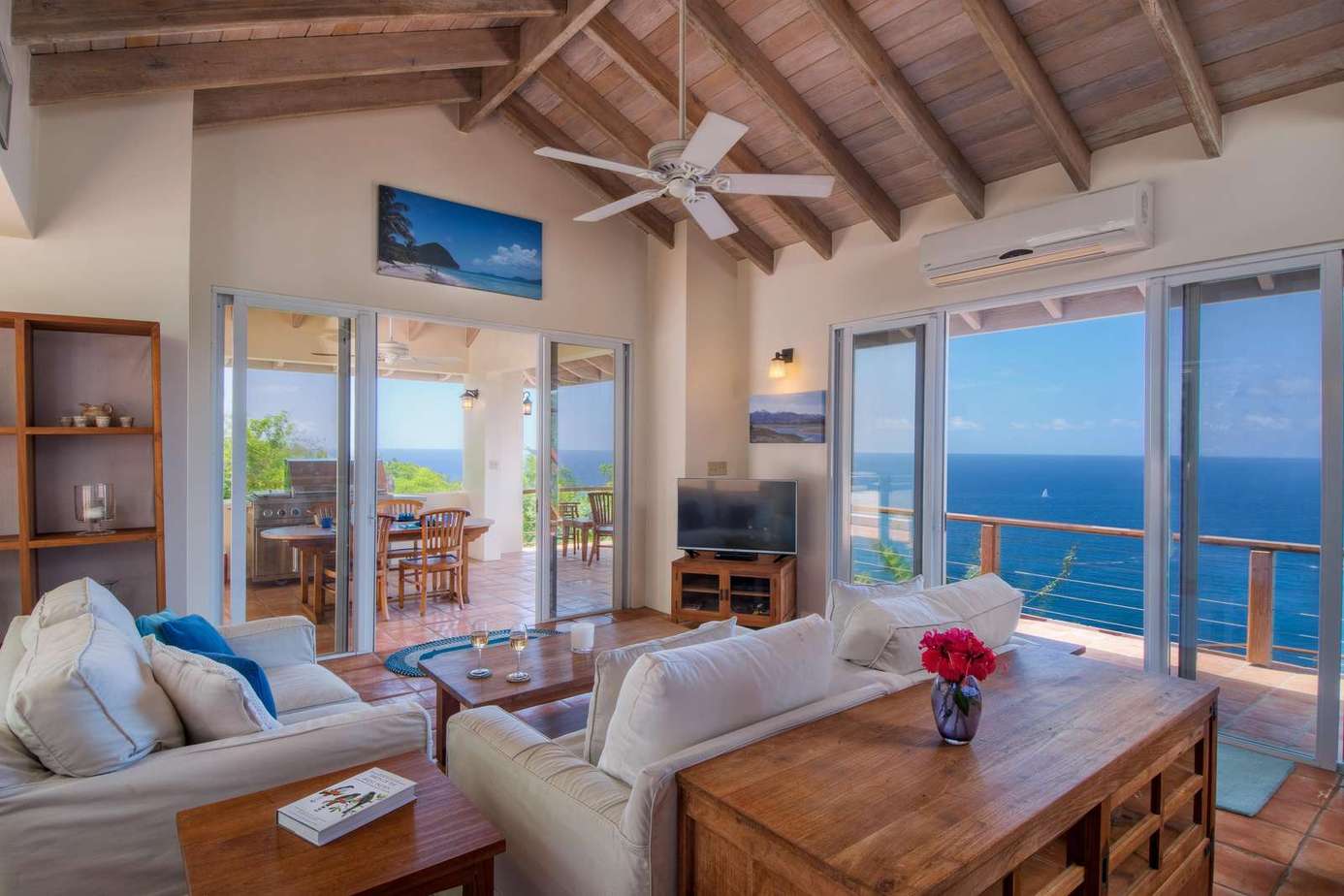 Sunlit living room with panoramic ocean views and cozy seating