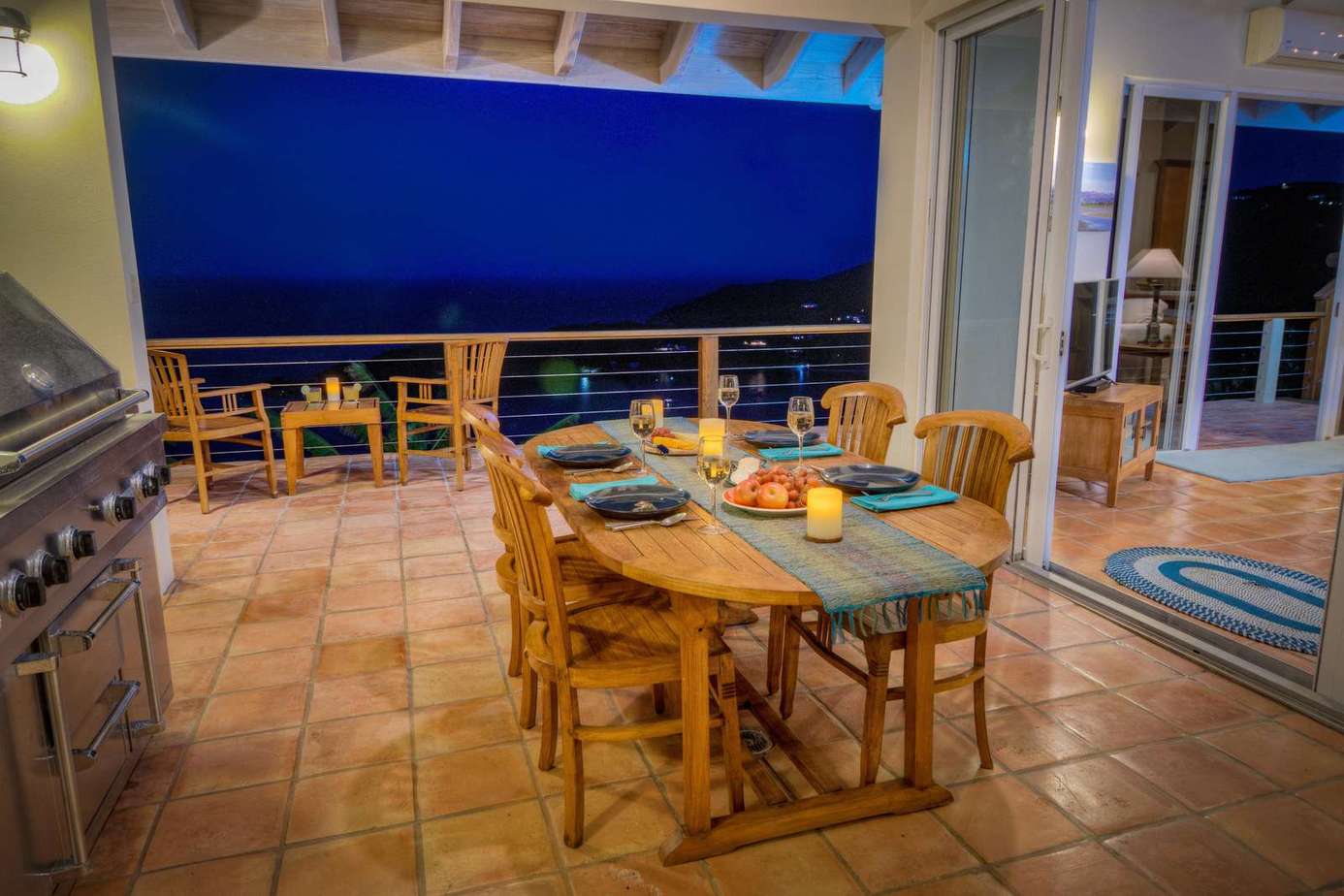 Spacious outdoor dining area with stunning nighttime views